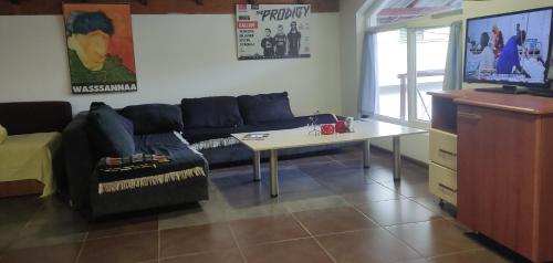 a living room with a couch and a table at Blue Lake hostel in Ohrid