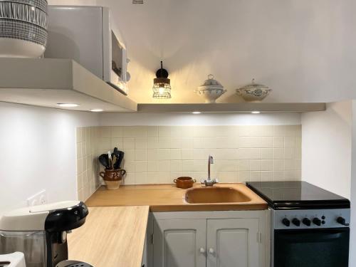 a kitchen with a sink and a stove at Housica & Co 2 in Ucciani