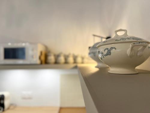 a white vase sitting on top of a counter at Housica & Co 2 in Ucciani