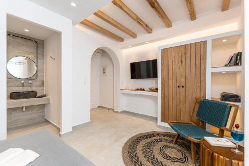 a living room with a television and a table and chairs at Spiros in Naxos Chora