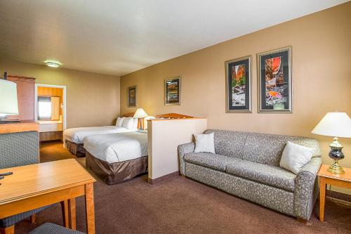 a hotel room with a bed and a couch at Clarion Suites St George - Convention Center Area in St. George