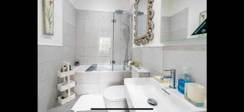 a white bathroom with a sink and a toilet at 97a 97b Captains House in Plymouth