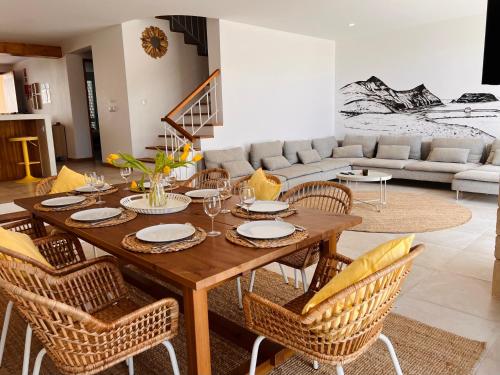 a living room with a wooden table and chairs at Casa da Pedreira in Porto Santo