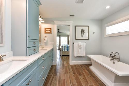 a bathroom with a large tub and a sink and a tub at Sea Spray in Siesta Key