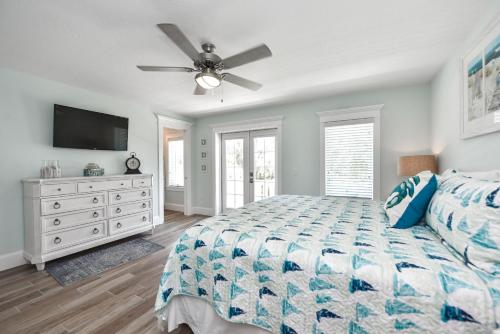 a bedroom with a bed and a ceiling fan at Sea Spray in Siesta Key