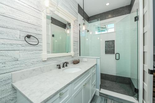 un bagno bianco con lavandino e doccia di Dry Dock a Siesta Key
