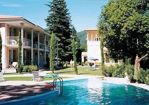 una grande piscina di fronte a una casa di Residence Ville Lago Lugano a Porto Ceresio