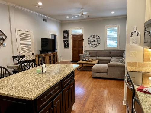 a kitchen and living room with a couch and a table at BamaNati in Tuscaloosa