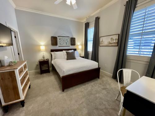 a bedroom with a bed and a table and a television at BamaNati in Tuscaloosa
