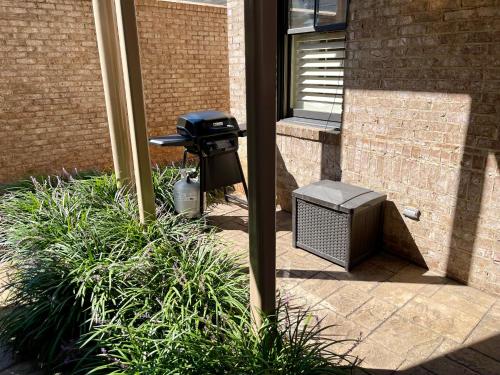 a black trash can sitting next to a building at BamaNati in Tuscaloosa
