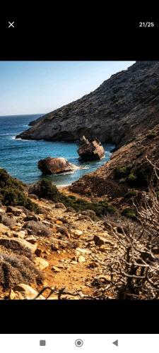 a view of a beach with rocks and the ocean at Mikro Kastro in Amorgos