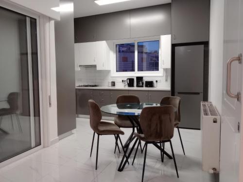 a kitchen with a table and chairs in a room at Zelea Deluxe Apartment (BREAKBOOKING CY) in Limassol