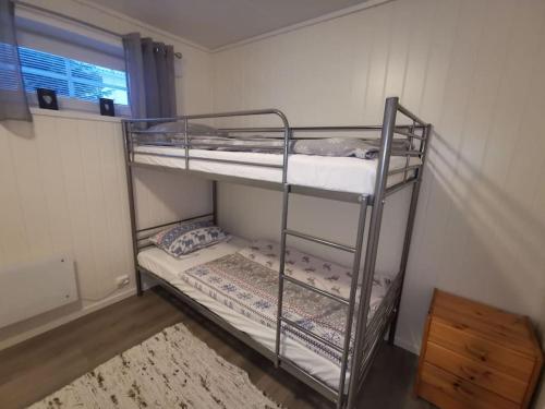 a bunk bed room with two bunk beds in it at Marta's Home-cozy appartment near the Airport in Andselv