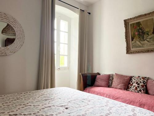 a bedroom with a bed and a window and a couch at Housica & Co 2 in Ucciani