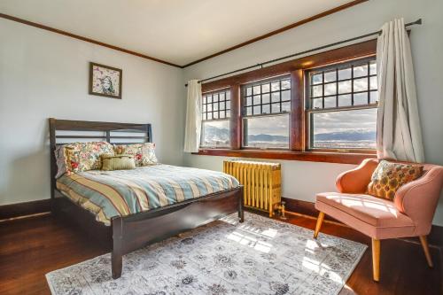 a bedroom with a bed and a chair and a window at Classic Butte Vacation Rental with Mountain Views! in Butte