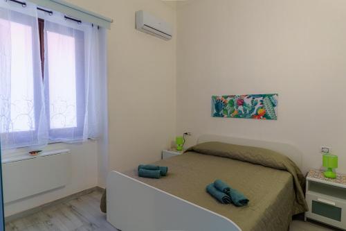 a small bedroom with a bed and a window at Casta Diva Holiday Rooms in Catania