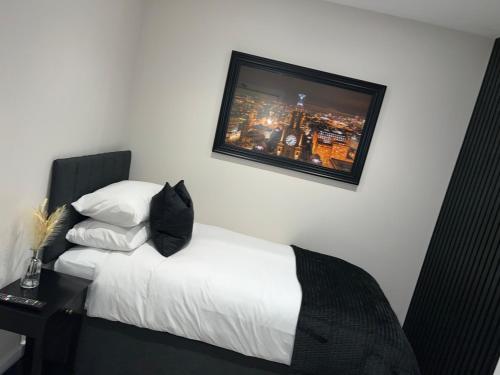 a bedroom with a bed with a tv on the wall at 128 Anfield Road in Liverpool
