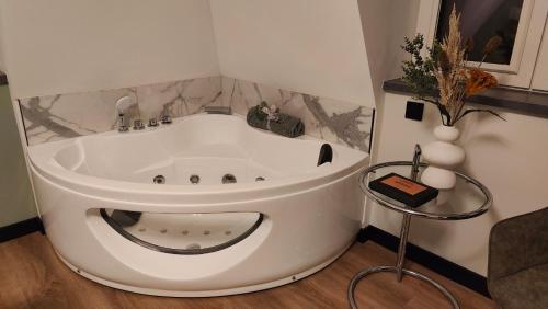 a large white bath tub in a room at Villa Savannah in Roelofarendsveen