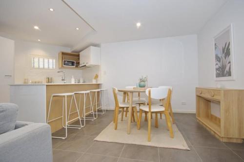 a kitchen and dining room with a table and chairs at Location, location, location - very large apartment in Brisbane