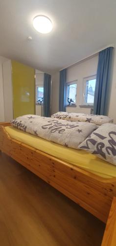 a bed with a wooden frame in a bedroom at Ferienhaus Sonni in Boppard