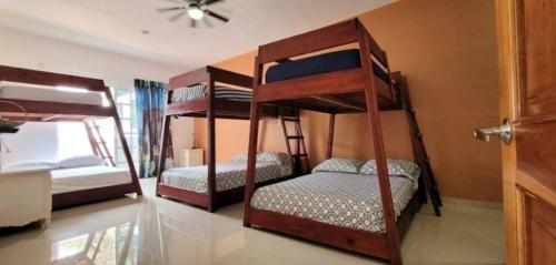 a bedroom with three bunk beds in a room at Esperanza in Valladolid