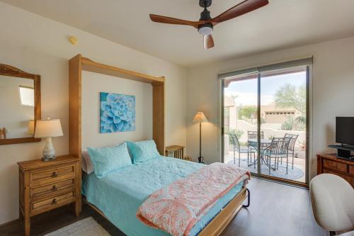 een slaapkamer met een bed en een glazen schuifdeur bij Sunny Tucson Vacation Rental with Patio! in Tucson