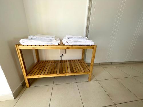 a wooden shelf with folded towels on top of it at Nysa8 in Paphos City