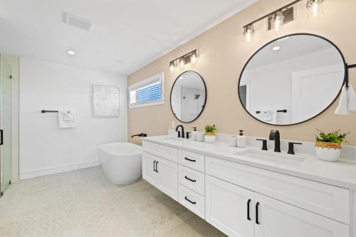 a bathroom with two sinks and a large mirror at Vitamin Sea in Sarasota