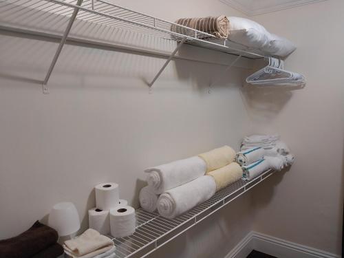 a closet with towels and toilet paper on a shelf at Private Guest House 2 bedrooms & 2 baths near Grace Bay Beach & Long Bay Beach. in Providenciales