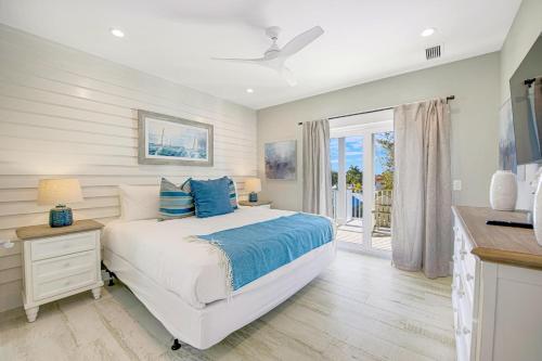 a bedroom with a bed with blue pillows at Beach Fanta Sea in Sarasota