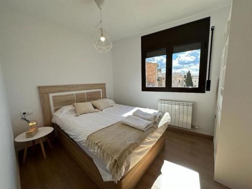 a bedroom with a large bed with a window at Best view from Pallars in Talarn