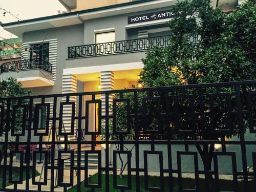 a black fence in front of a building at Hotel Antigone in Tirana