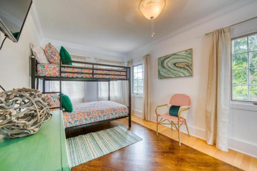 a bedroom with two bunk beds and a chair at John Ringling House in Sarasota