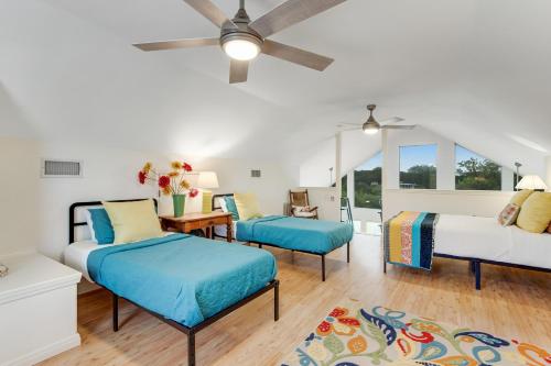 a bedroom with two beds and a ceiling fan at Redbird Retreat On Lake Travis in Marble Falls