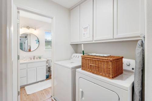 a white laundry room with a washer and dryer at Redbird Retreat On Lake Travis in Marble Falls