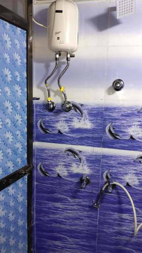 a bathroom with dolphins swimming in the water at Indian Drom Hostel-PG in Mumbai