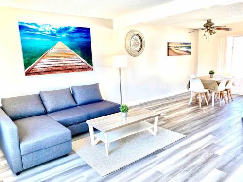 a living room with a blue couch and a table at Beautiful home near Disneyland. Entire place! in Orange