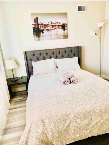 a bedroom with a bed with two towels on it at Beautiful home near Disneyland. Entire place! in Orange