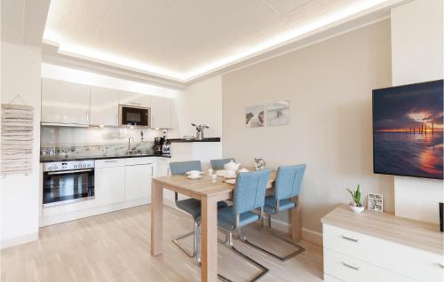 a kitchen and dining room with a wooden table and chairs at Prince in Binz