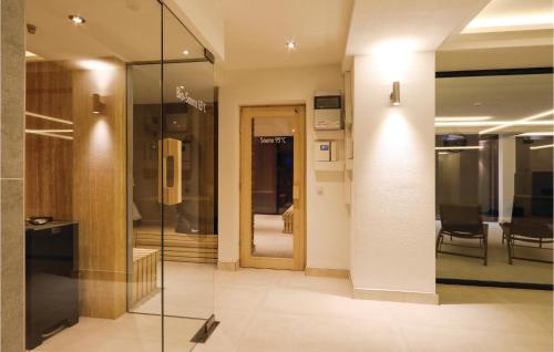 a hallway with a glass door and chairs in a building at Prince in Binz