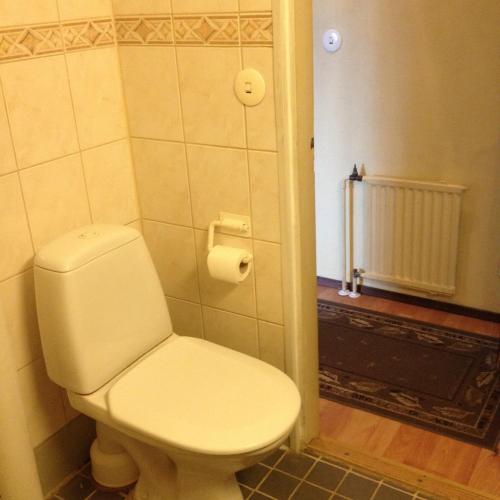 a bathroom with a white toilet in a room at Hotel Lamminpää in Tampere