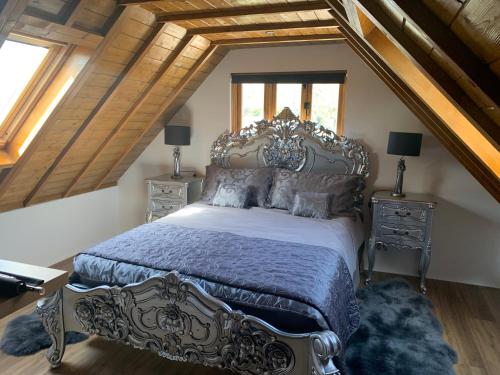 a bedroom with a large bed in a attic at Little Barn ideal for short stays in Bexley