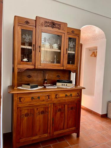 a large wooden cabinet in a room at Dammuso U Granatu in Pantelleria
