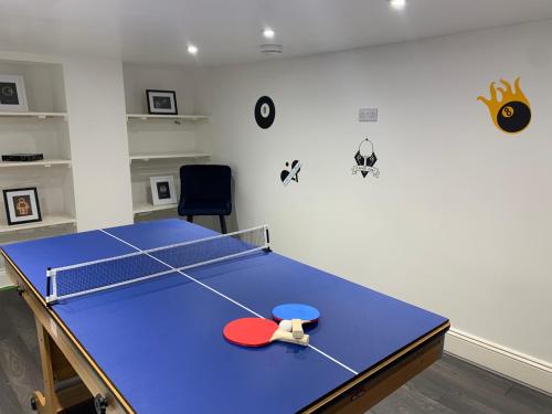 a ping pong table with a ping pong ball on it at Huge House, Near Rugby Stadium, Pool Table, Parking, Garden in Gloucester