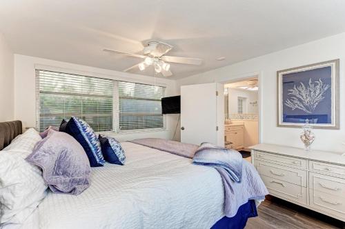 a bedroom with a bed and a ceiling fan at The Cottage on Lido Key in Sarasota