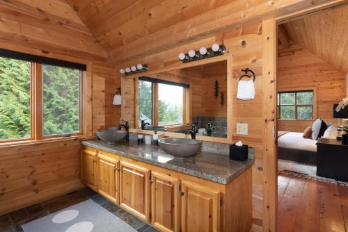 a bathroom with two sinks in a log cabin at Pinnacle Ridge 34 - Ski In Ski Out, Private Hot Tub, Recently Renovated, Gas Fireplace in Whistler