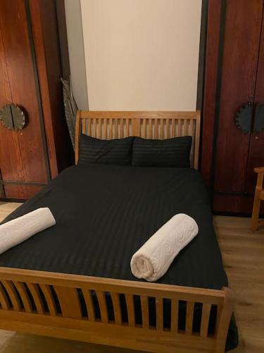 a bed with two towels on top of it at (023) Lovely 2 bedroom house London in London