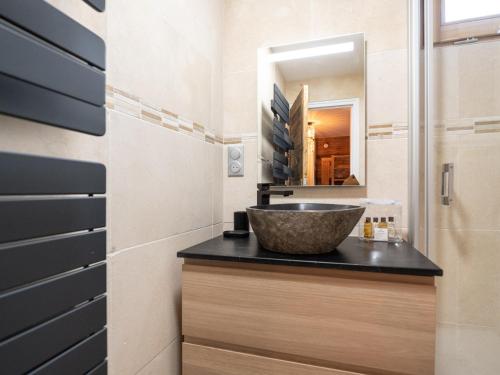 a bathroom with a sink and a mirror at Appartement rénové au cœur de l'Alpe d'Huez avec Wifi et Parking - FR-1-645-24 in LʼHuez