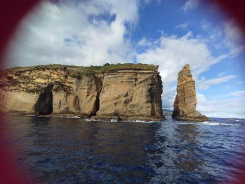 a view of two large rocks in the ocean at Um quarto da Casa Do Monte in Água de Alto