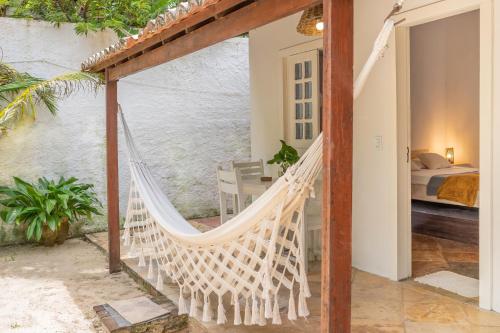 a hammock on the porch of a house at casa jasmin in Jericoacoara
